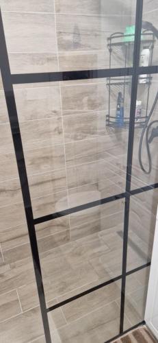 a glass shelf in a room with a wooden floor at LuxAsher in Floreşti