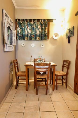 a dining room with a table and chairs at Venetis Luxury Apartments in Chios