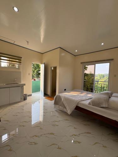 a large bedroom with a large bed and a bathroom at Octagon in Caylaway