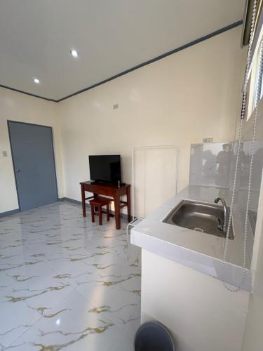 a kitchen with a sink and a desk in a room at Octagon in Caylaway