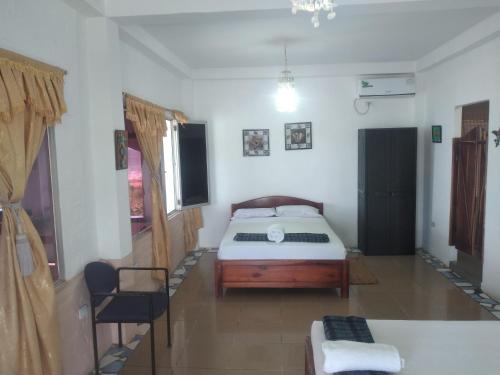 Una cama o camas en una habitación de Hospedaje Algarrobo Machalilla