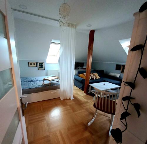 a living room with a room with a bed and a table at Apartment Dreamy Valley in Nenačovice