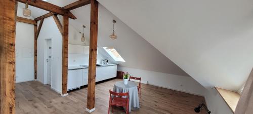 a kitchen and dining room with a table in a attic at Stryszek in Gdynia