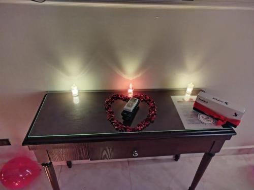 a table with two candles and a heart on it at Ramage Hotel & Resort in Cairo