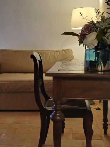 a living room with a table with a vase of flowers at Agriturismo Villa Gorgognano in Certaldo