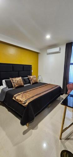 a bedroom with a large bed in a room at Torre 5 Mazatlán Versace Style in Mazatlán