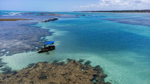 an aerial view of a boat in the water at CASA ACAYU in São Miguel dos Milagres