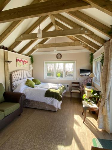 a bedroom with a large bed and a window at The Garden Room in Spittal