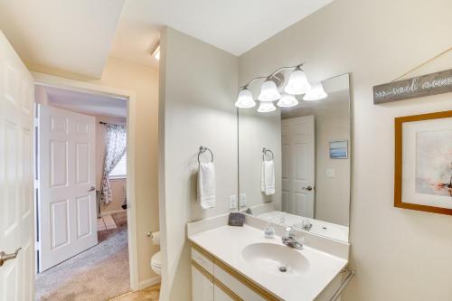 a bathroom with a sink and a mirror at 3 Mi to Branson Landing Condo with Pool Access in Branson