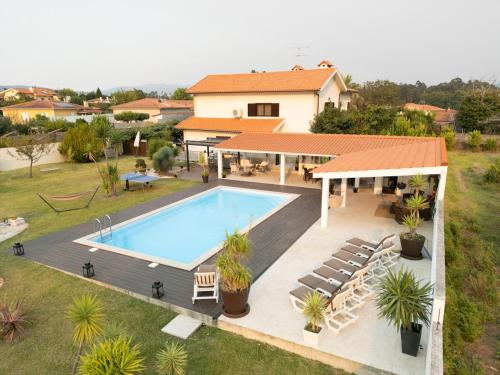an aerial view of a house with a swimming pool at VILLA DA COSTA - SUNSET POOLHOUSE in Alvarães