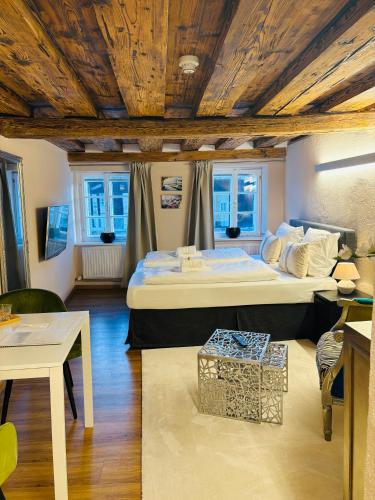 a bedroom with a large bed with a wooden ceiling at APT. STONE-LODGE in Salzburg