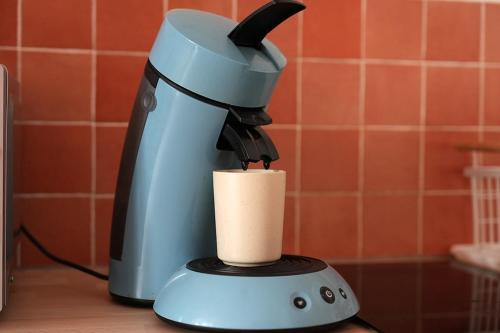 a blue blender sitting on a counter with a cup at Charmant appartement Lille Centre St Michel in Lille