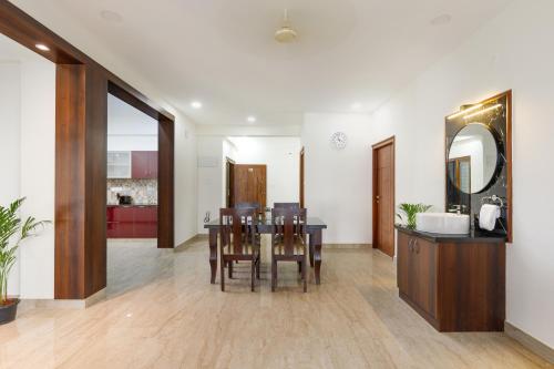 a kitchen and dining room with a table and chairs at OBS Serviced Apartments HSR Layout Bangalore in Bengaluru