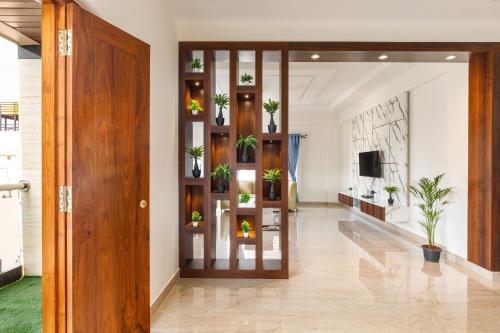 a hallway with plants on shelves in a building at OBS Serviced Apartments HSR Layout Bangalore in Bengaluru