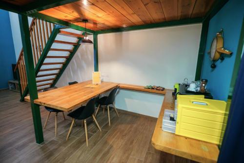 a room with a wooden table and a staircase at Terminal 1 Guest House in Naples