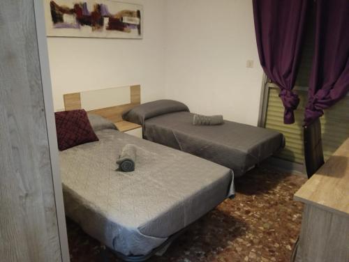 a room with two beds and a couch at Casa Paco in Linares