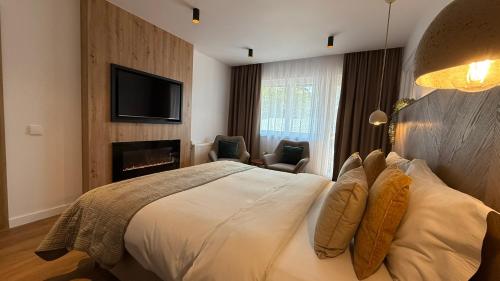 a hotel room with a bed and a fireplace at Casa Cristina in Braşov