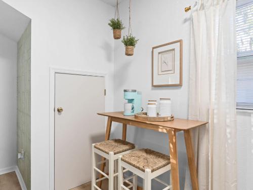 a small table with two stools in a room at SUPER BOHO- At LAKE TOHO's WATER SLEEPs 6 in Kissimmee