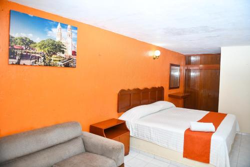 a hotel room with a bed and a couch at Hotel Uxulkah in Campeche