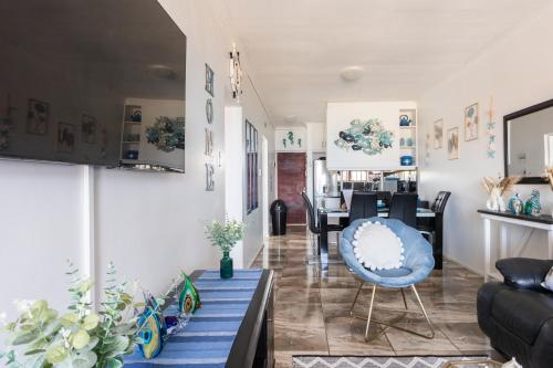 a living room with a couch and a table at Ocean View Escape with Private Rooftop -Sancta Maria in Kingsburgh