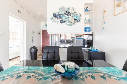 a dining room with a table and two chairs at Ocean View Escape with Private Rooftop -Sancta Maria in Kingsburgh
