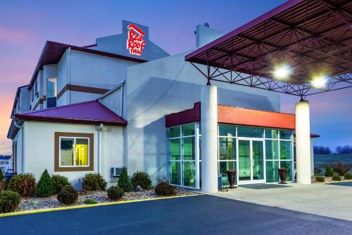 a building with a sign on the side of it at Red Roof Inn Georgetown, IN - Louisville West in Georgetown