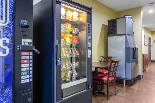 a soda vending machine in a restaurant with a table at Red Roof Inn Georgetown, IN - Louisville West in Georgetown