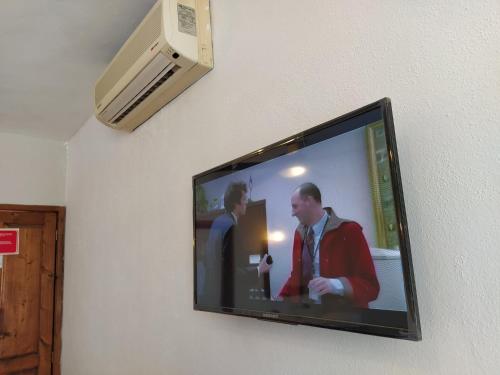 a flat screen tv hanging on a wall at Econo Beach Cantamar in La Paz