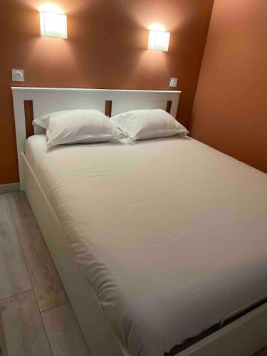 un grand lit blanc avec deux oreillers dessus dans l'établissement SUNRISE - Golf de Pont Royal, à Mallemort