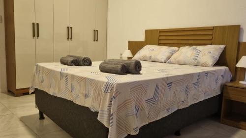 a bedroom with a large bed with two pillows on it at Perla Sibauma in Tibau do Sul