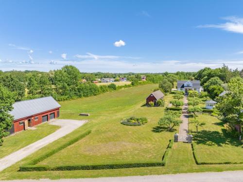 an aerial view of a farm with a building and a church at Charming Country House - Bedding & Towels included in Färjestaden