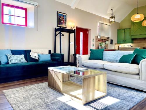 a living room with a couch and a coffee table at Summerhill Byre in Ballymena