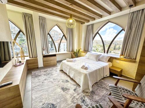 a bedroom with a bed in a room with large windows at Apartment in Jounieh - J707 in Al Bāţiyah
