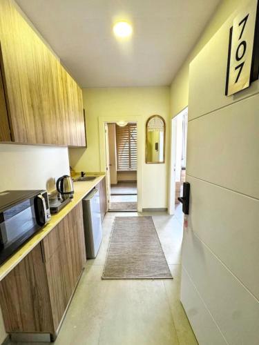 a kitchen with yellow walls and wooden cabinets at Apartment in Jounieh - J707 in Al Bāţiyah