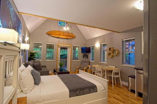 a bedroom with a bed and a living room at Tide and Trail- Cabin in Ucluelet in Ucluelet
