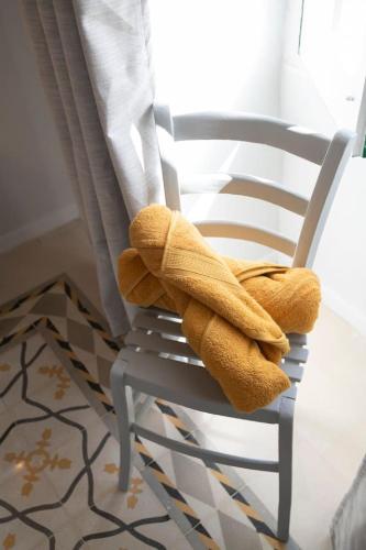 a towel sitting on a chair in a room at Maltese Charm - Seaside Stay - Table Soccer in St. Julianʼs