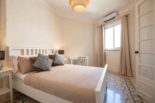 a bedroom with a large bed with a window at Maltese Charm - Seaside Stay - Table Soccer in St. Julianʼs