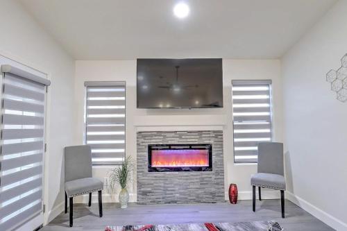 a living room with two chairs and a fireplace at Executive Retreat near State Farm Stadium in Glendale