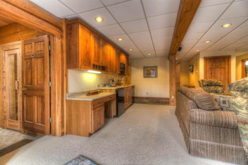 a kitchen with wooden cabinets and a couch in a room at Most Luxury 7000 Sq ft Log Estate with Pool Hot Tub Sauna in Wilmington