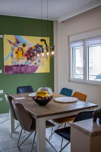 a dining room table with a bowl of fruit on it at Anastasia Meteora Residence in Kalabaka