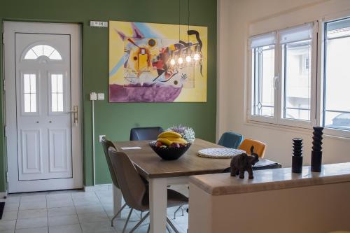 a dining room with a table and a painting on the wall at Anastasia Meteora Residence in Kalabaka