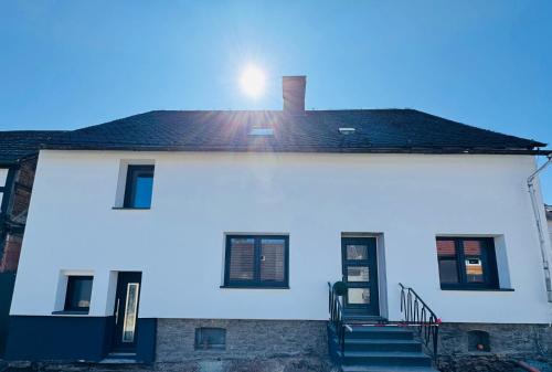 a white house with a roof with a staircase at Ferienhaus Am Südwall, 220qm in Medebach