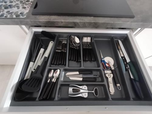 a drawer filled with kitchen utensils in a refrigerator at Apartament przy Armii Krajowej I in Kluczbork