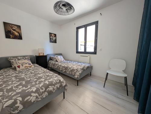 une chambre avec un lit, une chaise et une fenêtre dans l'établissement Villa privative avec jardin - 15 min Valence, à Châteaubourg