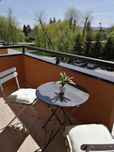 a small table and two chairs on a balcony at Sofija in Veliko Gradište