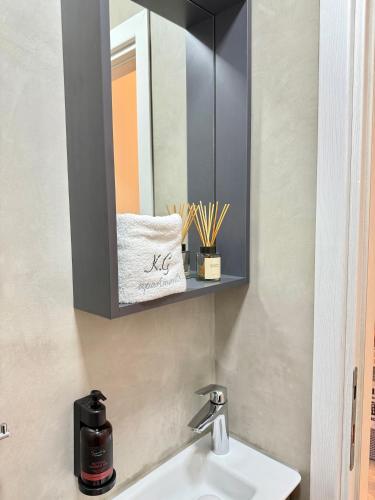 a bathroom with a sink and a mirror at K.G APARTMENT 2 in Pefkohori