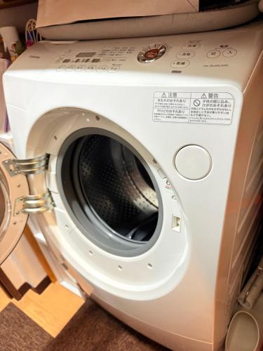 a washing machine with a box on top of it at hostel sunflower301 in Osaka