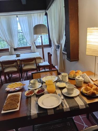 a table with breakfast foods and drinks on it at Chalet Las Nenas B&B in Mar del Plata