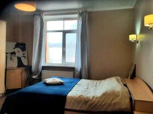 a bedroom with a bed and a window at Charming Old Town Retreat in Rīga