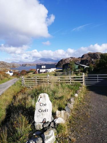 a stone sign that says give graft on a road at The Croft in Whale Islet